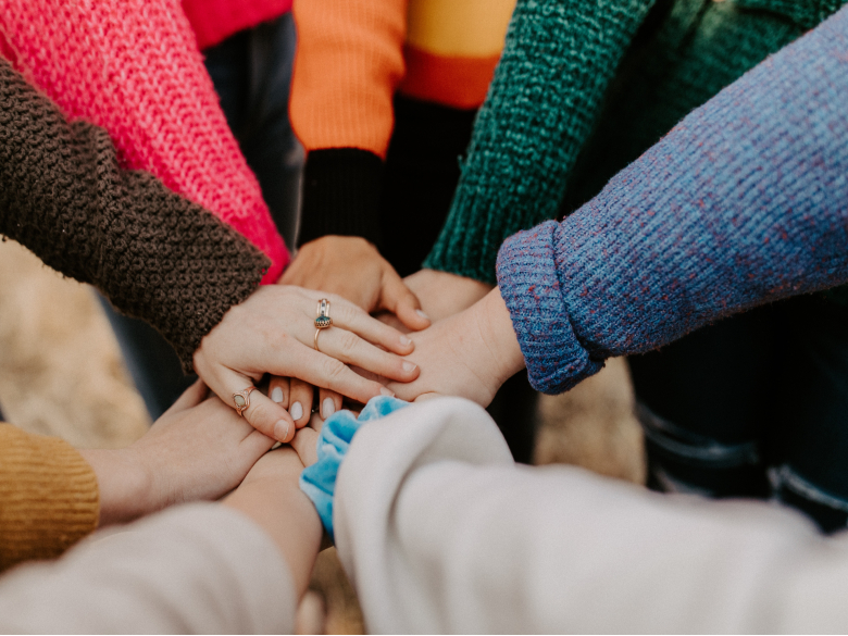 Christian friends holding hands.