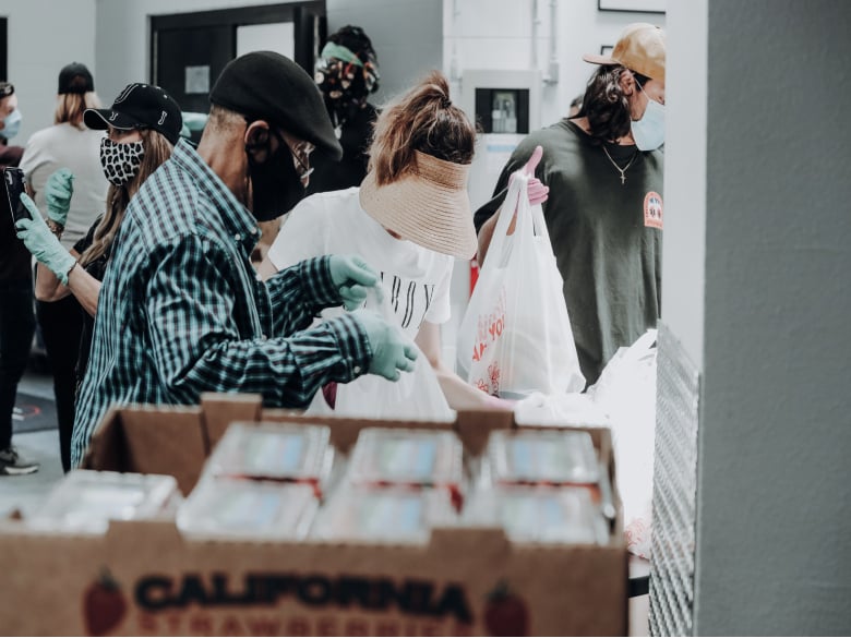 Volunteers distributing food at a food pantry.