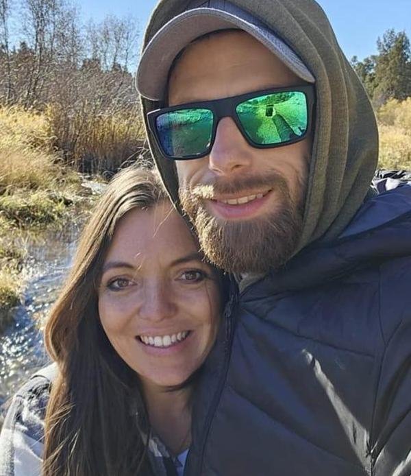 couple in front of river together