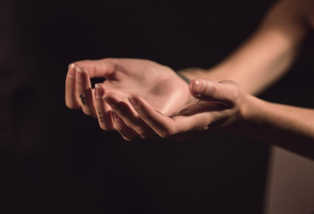 dark background with ladies' hands reaching out in surrender/worship