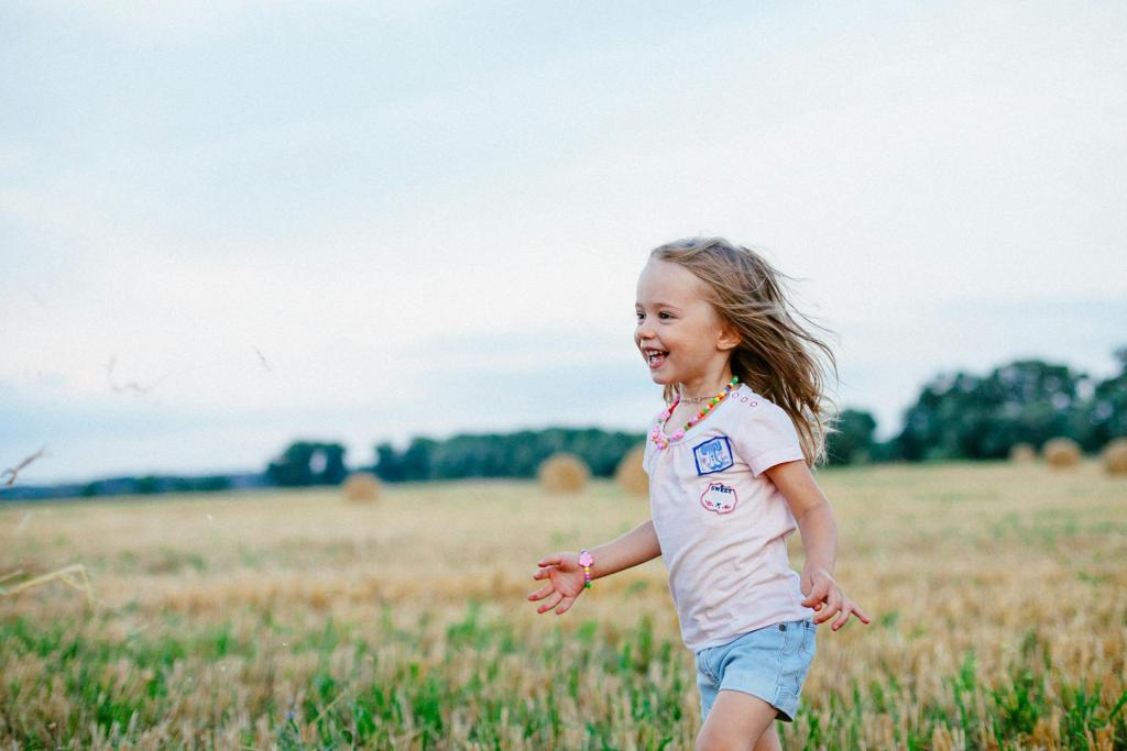 girl smiling walking through field of grass