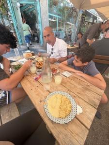 Enjoying fresh hummus at a restaurant in the Lewinsky Market in Tel Aviv