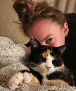 Cat sleeping next to woman