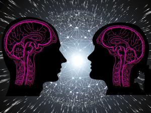 Silhouettes of man and woman with outline of their brains against a spacey backdrop