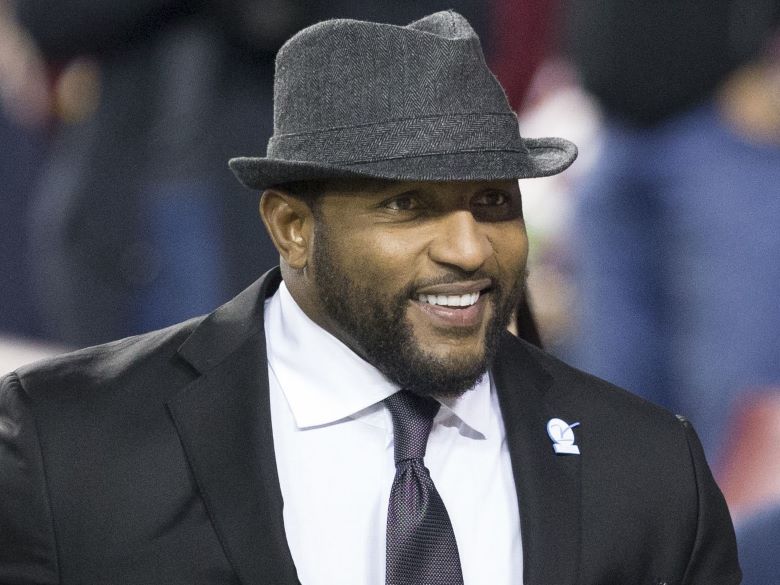 Closeup of Ray Lewis wearing a hat, suit, and tie