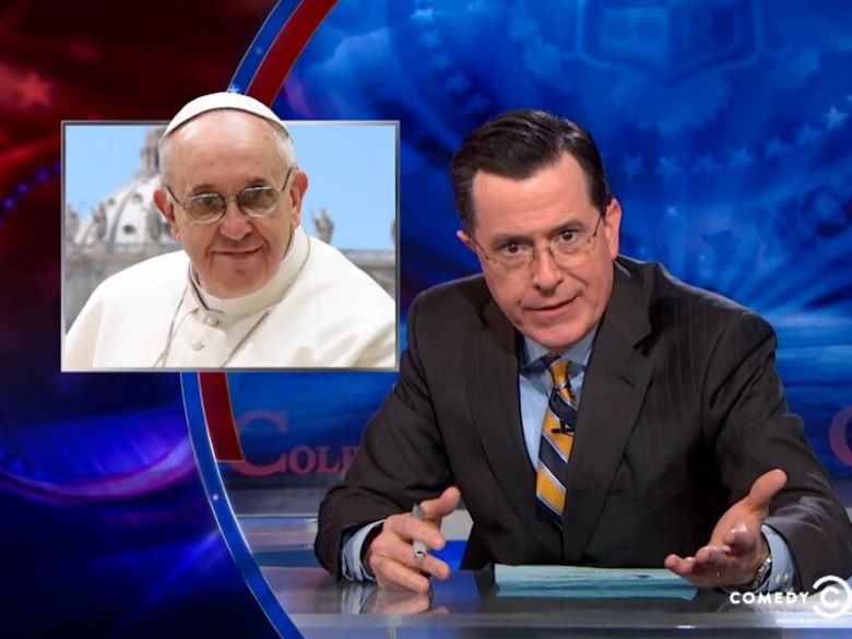 Stephen Colbert on his show with an inset picture of the Pope
