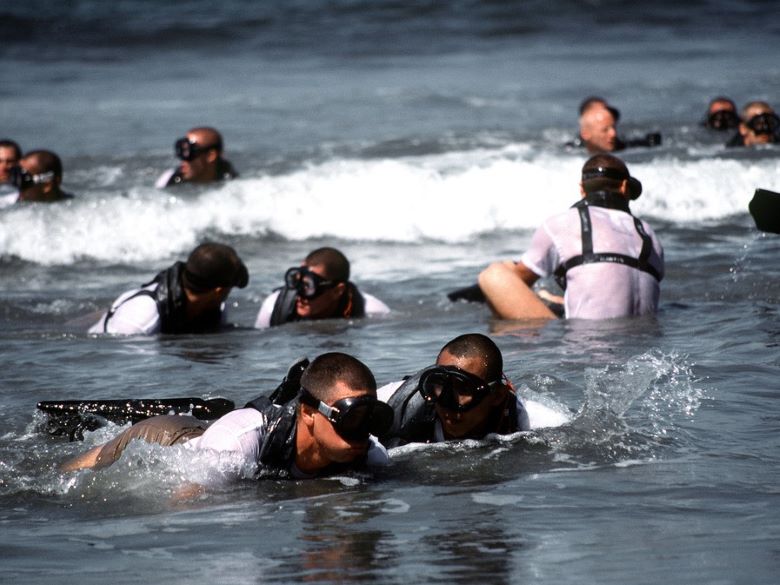 Navy SEAL swim buddies paired up in the water.