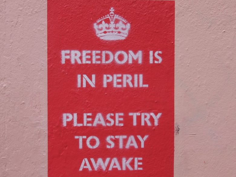 Sign on wall in the UK--Freedom is in Peril. Please try to stay awake.