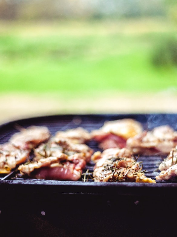 a hot grill with meat cooking