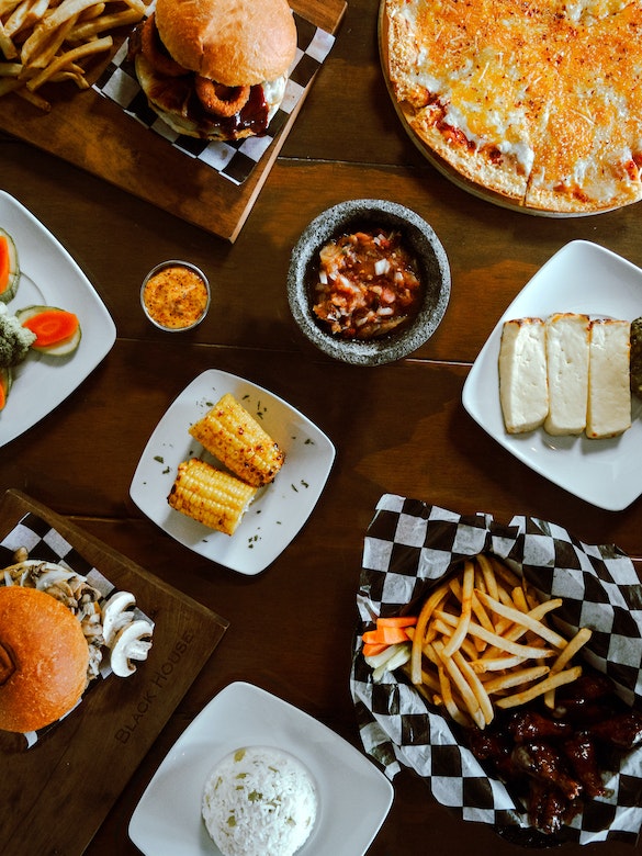 a table is filled with plates containing many different foods
