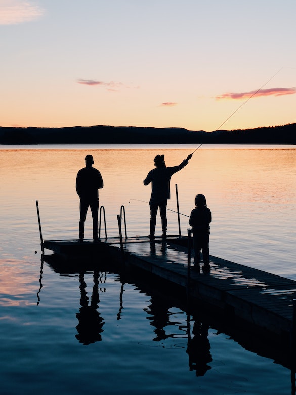 A father fishes with his kids