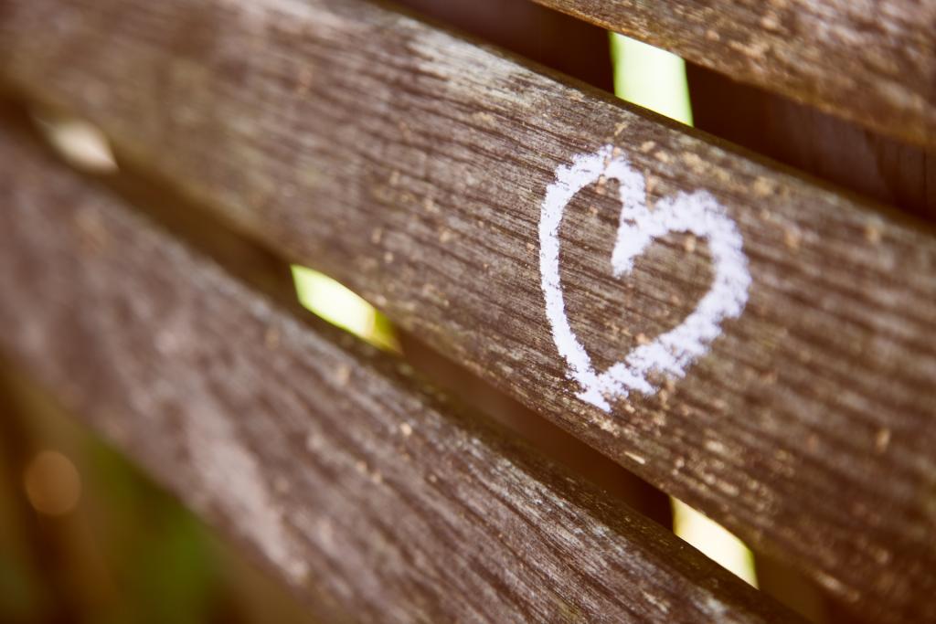 A heart drawn in chalk on a wooden bench