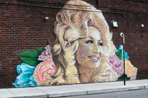 Painting of Dolly Parton on a wall
