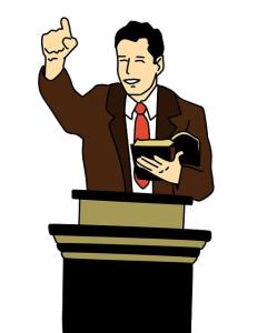 Preacher standing at pulpit holding Bible