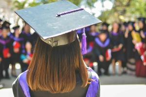 Woman wearing academic cap - view from behind