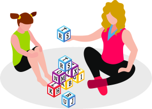 A woman and young girl sitting on a mat with several learning blocks (bearing letters of the alphabet) between them.