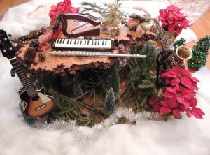 Winter scene with ukulele, lilly harp, mouth piano and flute surrounded by artificial snow and poinsettias