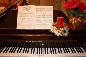 piano keyboard with music book and Christmas decorations