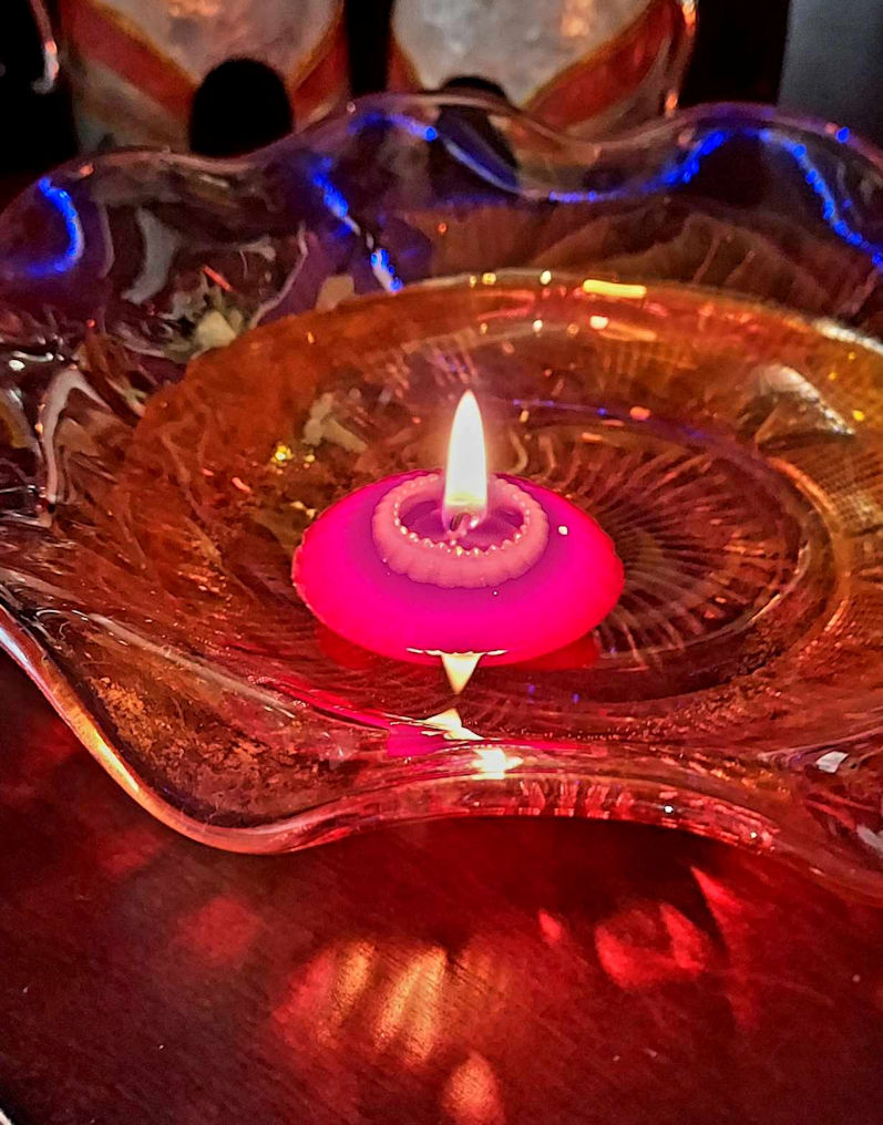 red candle floating in water
