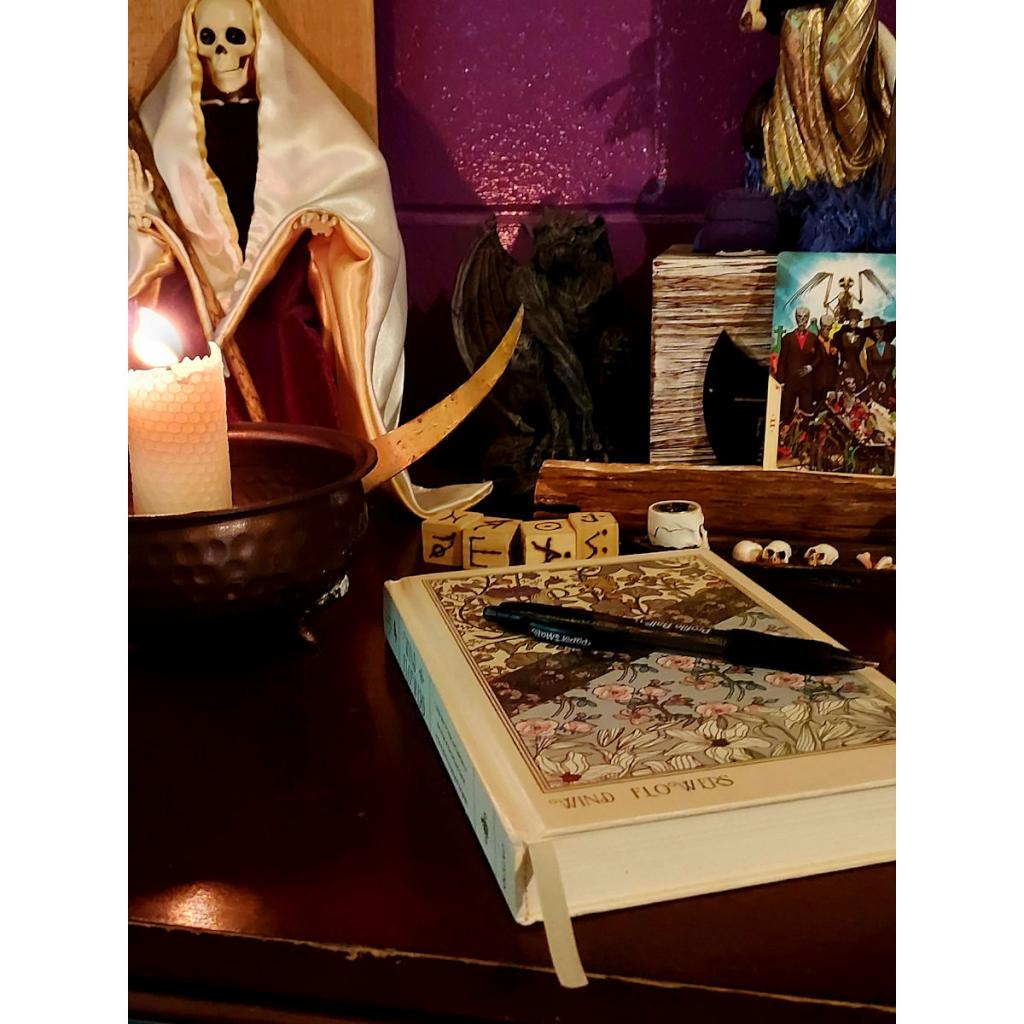 a book on a table with a candle