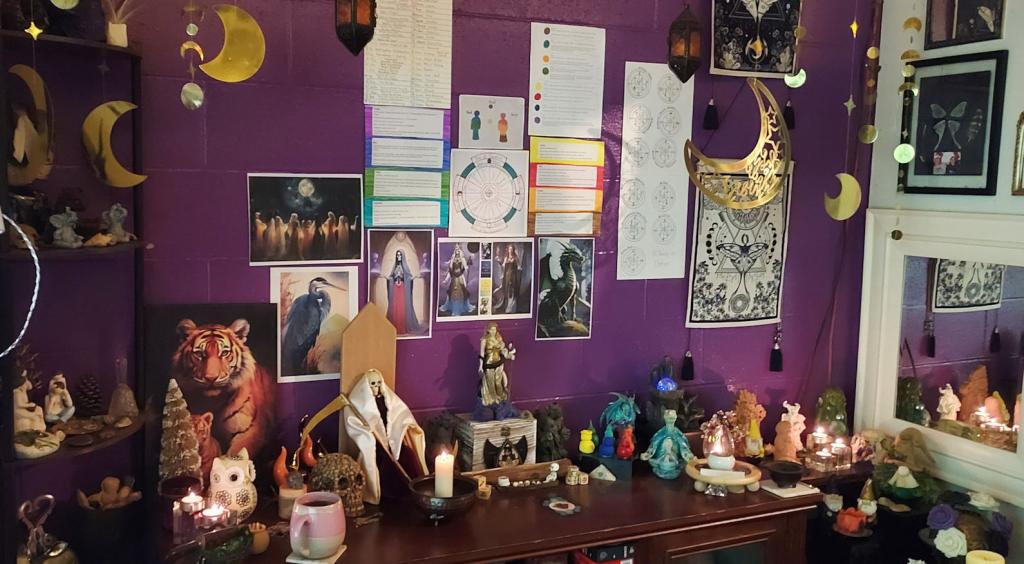 an altar room with statues, pictures, and candles