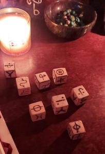 rune dice illuminated by a candle
