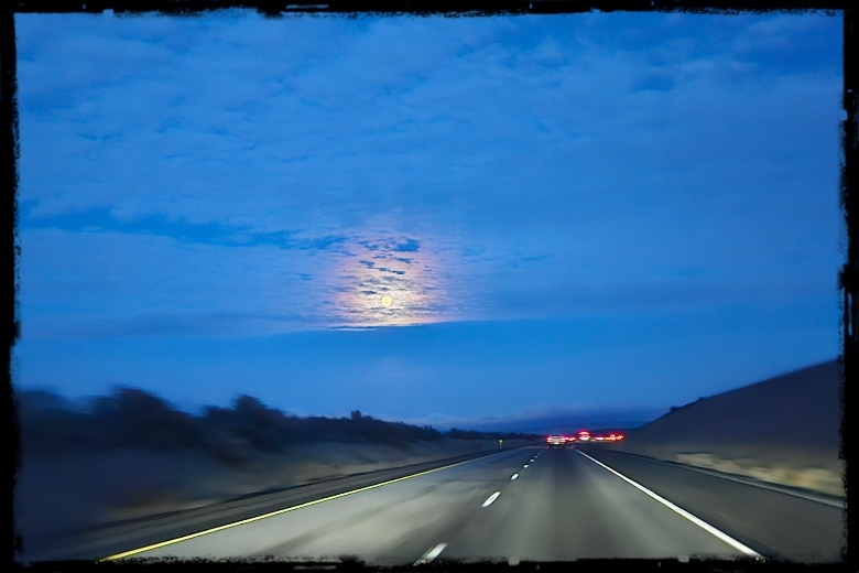 Following Jesus: Sometimes the Road Is Long - Full moon in a cloudy sky above the highway