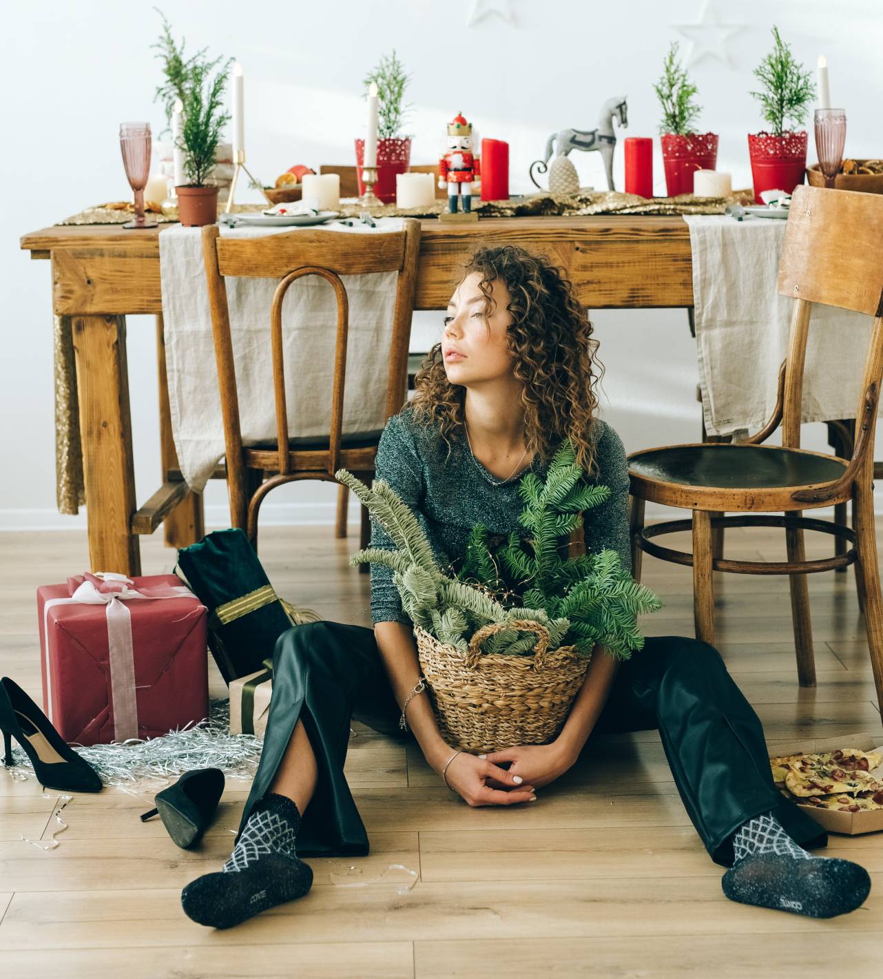 Woman on floor by Holiday decorations 