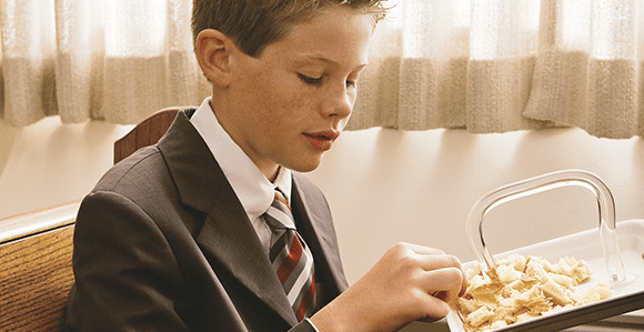 Young man partaking of the sacrament