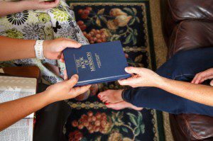 Handing out a copy of the Book of Mormon