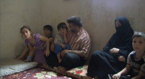 A Syrian refugee family in cramped quarters