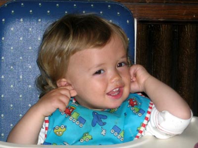 Child with fingers in her hears