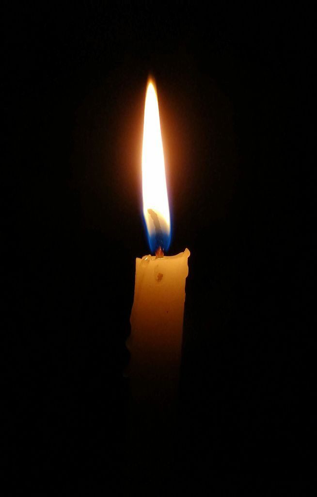 A candle, glowing in the dark
