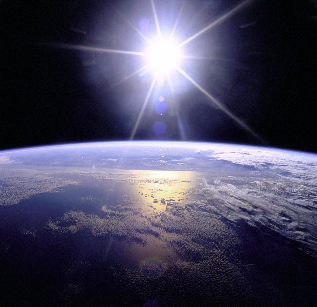 NASA shot of sunburst above the Earth