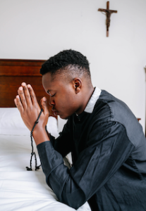 Clergyman kneeling in prayer