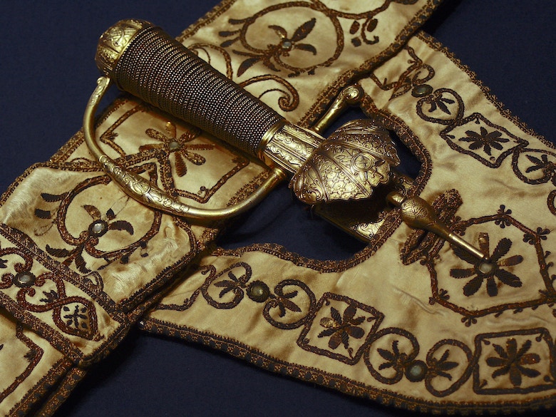 Gold thread embroidered sword belt with gold hilt of sword