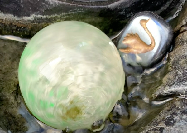 Coco's engraved swan stone in her garden water fountain