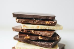 stack of white, dark, and milk chocolate with nuts