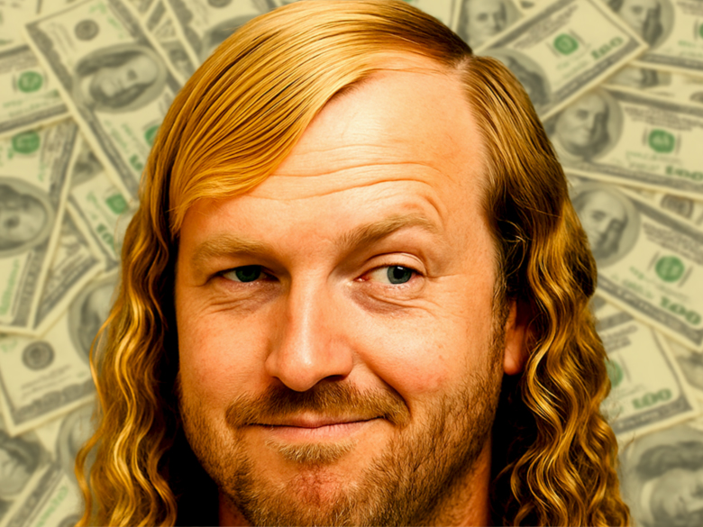 Close-up satirical portrait of a smiling man with a dramatic blonde combover and curly hair, smirking slightly in front of a background filled with $100 bills.