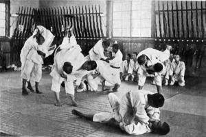 Students practice jiu jitsu on one another 