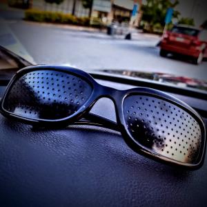 Pinhole glasses on car dashboard