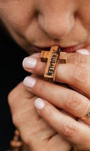 A Person Praying with cross