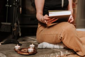 Woman with book and candles