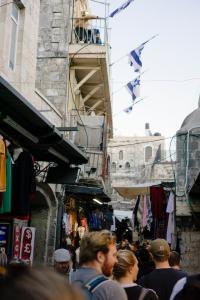 People walking on street in Israel with flags flying