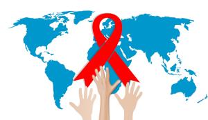 World AIDS day red ribbon with globe and hands reaching up