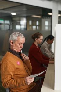 Man reviewing an election ballot