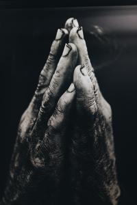 hands touching in prayer