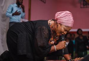 A woman on her knees praying