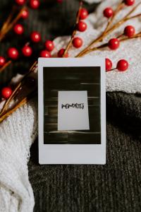 Photo of a note that says memories with berries surrounding on top left.
