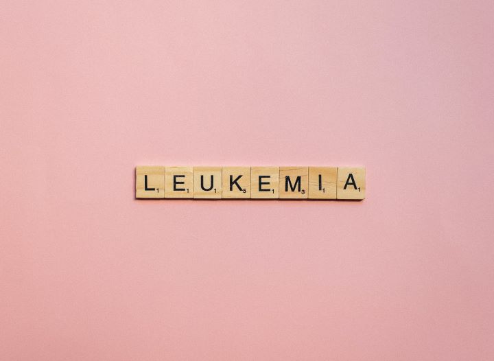 Using Scrabble tiles, the photographer spells out "leukemia."